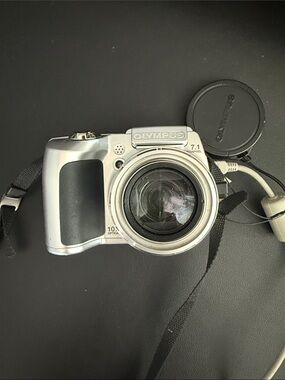 Olympus Silver Digital Camera with Black Grip and Strap
